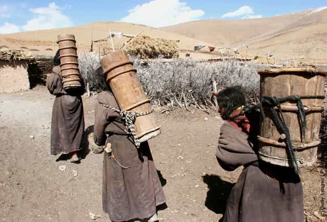 Kangba Women Fetch Water With Traditional Barrels