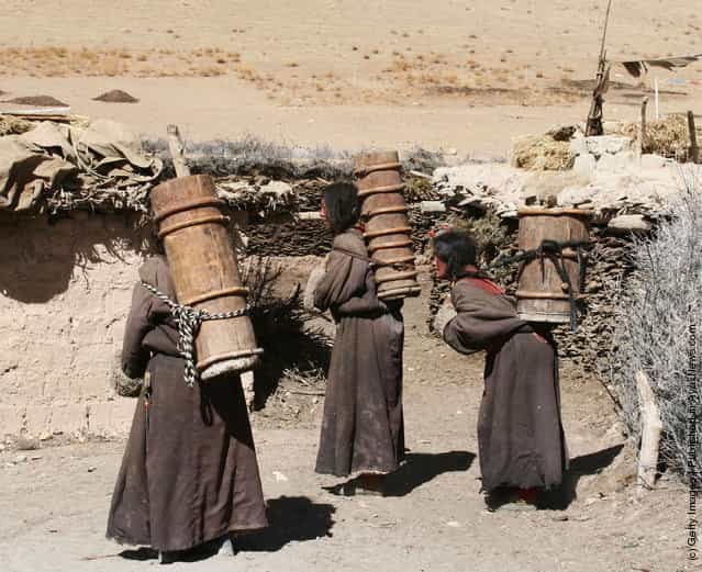 Kangba Women Fetch Water With Traditional Barrels