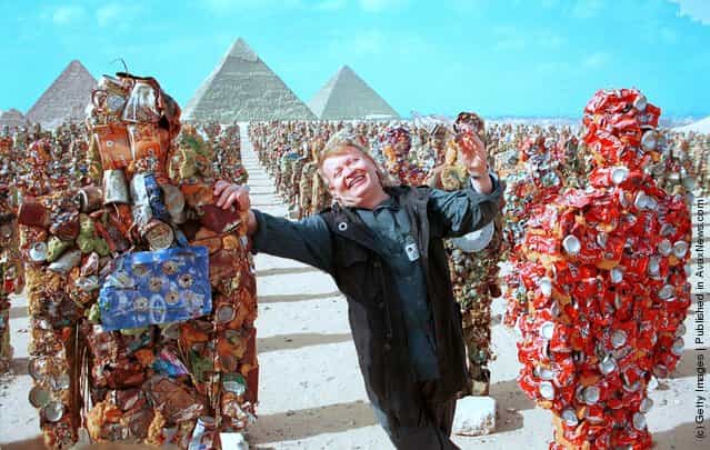 German artist Ha Schult stands with his trash people below the pyramids May 15, 2002 in Giza, Egypt