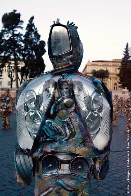 Trash People, life-size representations of people created from consumer refuse like tin cans and metal containers, created by German artist Ha Schult, populate the Piazza del Popolo on March 23, 2007 in downtown Rome, Italy