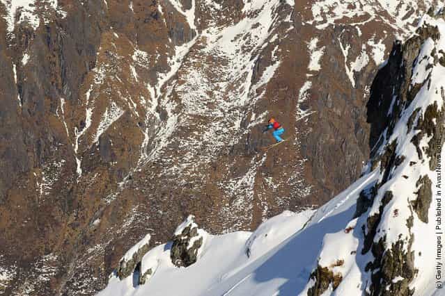 Freeskier Sam Foster of Australia launches off a drop during the World Heli Challenge freestyle day in backcountry at Minaret Station on July 31, 2011 in Wanaka, New Zealand