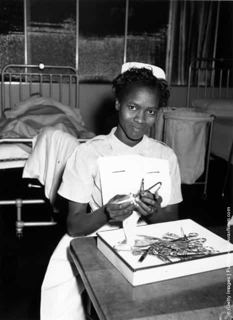 7th November 1958: Christina Oyemaja from Nigeria cleaning surgical instruments in Brook General Hospital, Blackheath, London. She is one of the nurses from many different countries who are receiving training at the PTS (preliminary training school) of the Woolwich group of hospitals