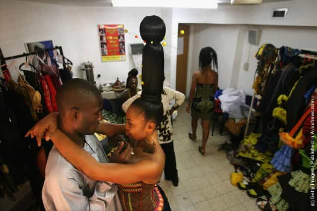 A Nigerian fashion model hugs her makeup artist during a fashion show to promote ethnic fashion June 13, 2006 in Tel Aviv, Israel
