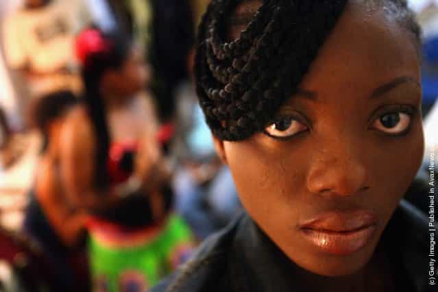 A Nigerian fashion model looks to the camera behind the curtain of a fashion show to promote ethnic fashion June 13, 2006 in Tel Aviv, Israel
