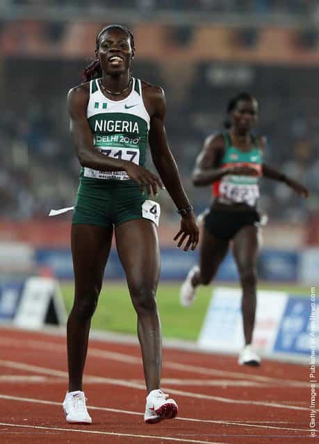 Muizat Odumosu of Nigeria smiles after winning the womens 400 metres hurdles final at Jawaharlal Nehru Stadium during day seven of the Delhi 2010 Commonwealth Games on October 10, 2010 in Delhi, India