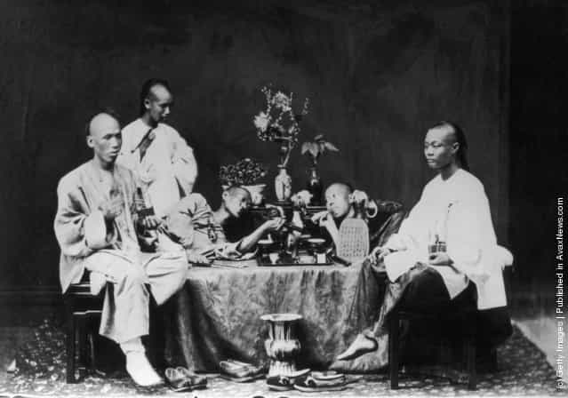circa 1900: A group of opium smokers in Hong Kong