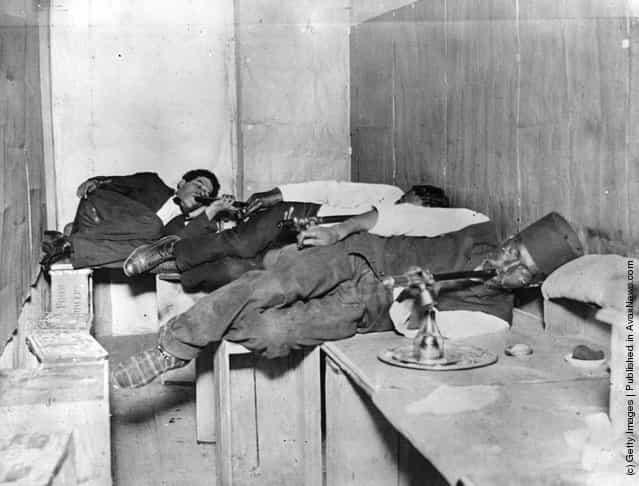 1925: Three men relaxing and smoking opium