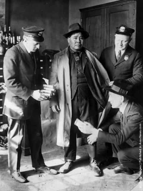 A Chinese seaman being arrested at the port of New York for the attempted smuggling of opium, 1926