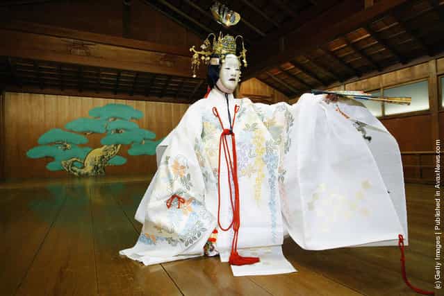 A traditional Japanese Noh actor gets his masks and costumes put on prior to demostrating a performance of the ancient theatrical art