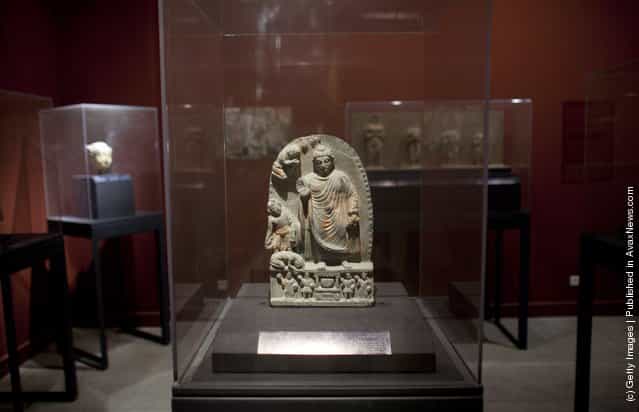 An ancient sculptures, pottery and bowls is displayed in the Kabul Museum August 4, 2011 in Kabul, Afghanistan