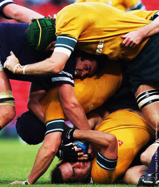George Smith of Austalia (bottom) finds himself crushed in a maul during the International Friendly match between Scotland and Australia at Hampden Parkon