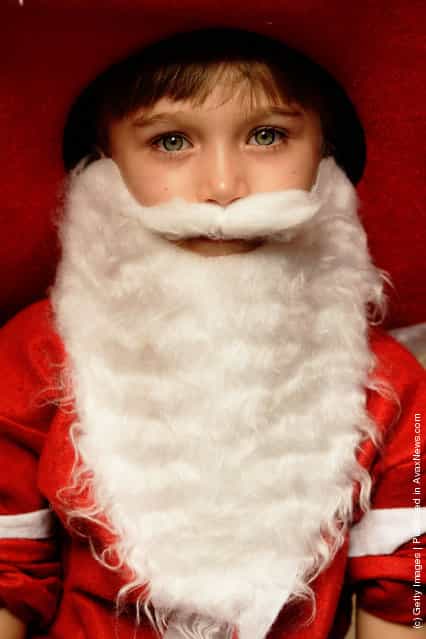 A girl dressed as Santa attends the Variety Santa Fun Run at Town Hall