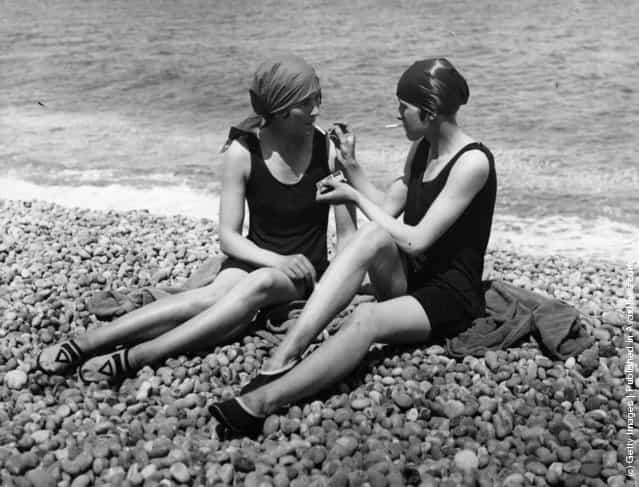 Two bathers enjoy a cigarette on the beach, 1926