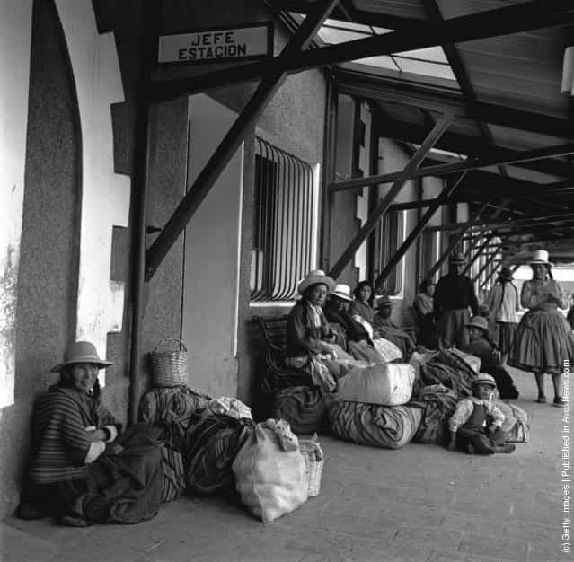 Passengers wait for the next train at Cuzco railway station, central Peru, 1950
