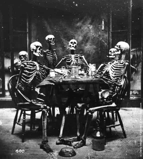 Six skeletons smoking around the dinner table