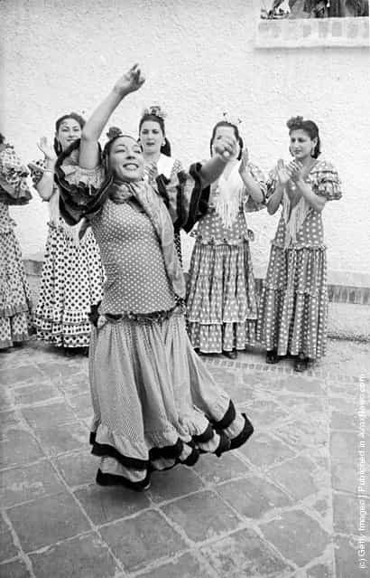 Andalusian gypsies in traditional dress dancing the flamenco