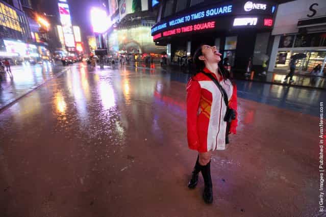 Yuria Celidwen tastes the rain in a nearly deserted Times Square as Hurricane Irene approaches