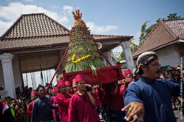 Volunteers of Kraton Palace, known as Abdi Dalem, carry Gunungan Lanang from Kraton Palace to the Great Mosque Kauman in Yogyakarta, Indonesia