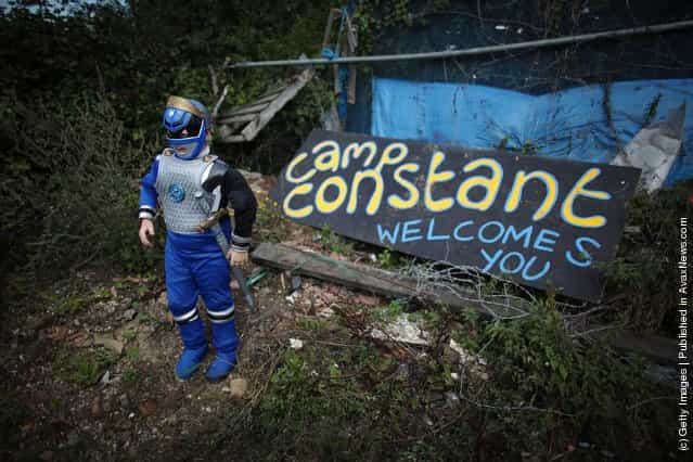 Patrick Sheridan, aged seven, poses for a photograph in a Power Rangers outfit at the entrance to Camp Constant at Dale Farm travellers camp
