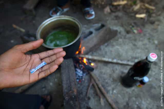 Thai drug user adds the powder from an illegal pill called mano one to the popular cheap narcotic drink, 4 x 100