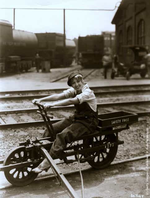 Joan Blondell the friendly comedienne is riding on an American railway truck