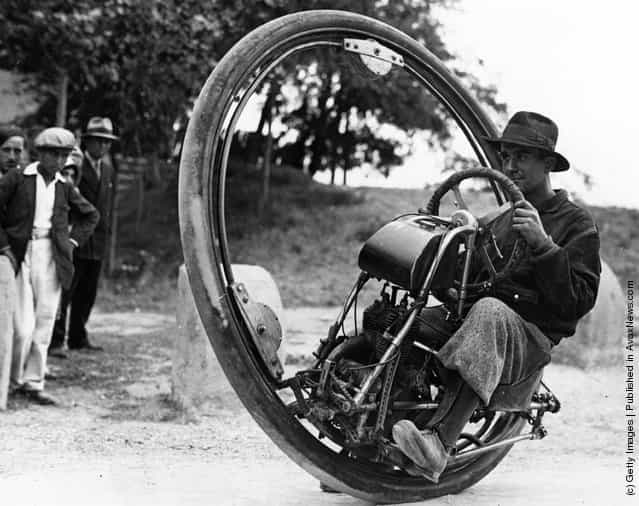 Swiss engineer Gerder at Arles, France on his way to Spain in his Motorwheel, a motorcycle with a wheel which runs on a rail placed inside a solid rubber tyre
