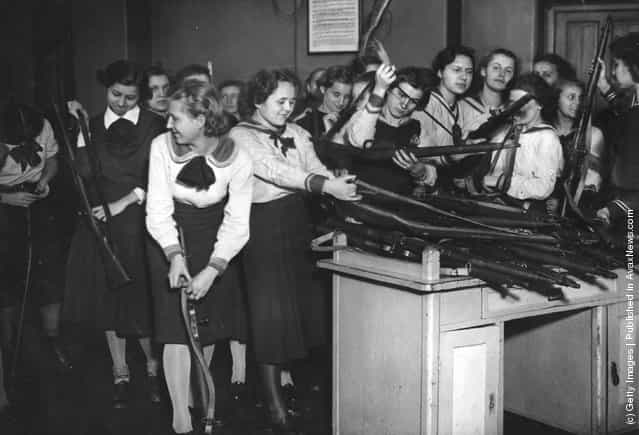 1939: Military training has been introduced to the schools in Budapest. Here the pupils of a girls school are issued with their arms