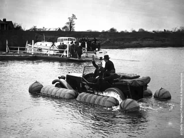 1931: Captain Malin with an amphibian Riley car going down the Severn