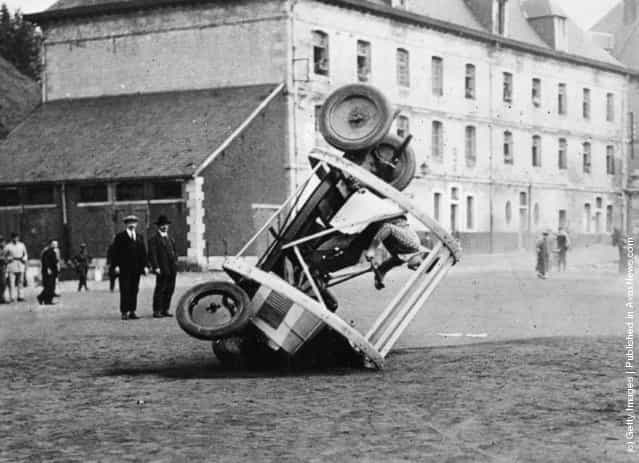 1925: A stunt car being rolled