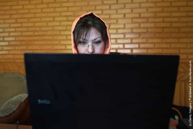 Afghan IT specialist Masuma Asaghari checks anti-virus programs on a laptop