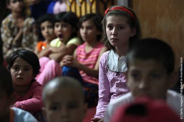 Afghan orphans watch cartoons at the Satara Orphanage