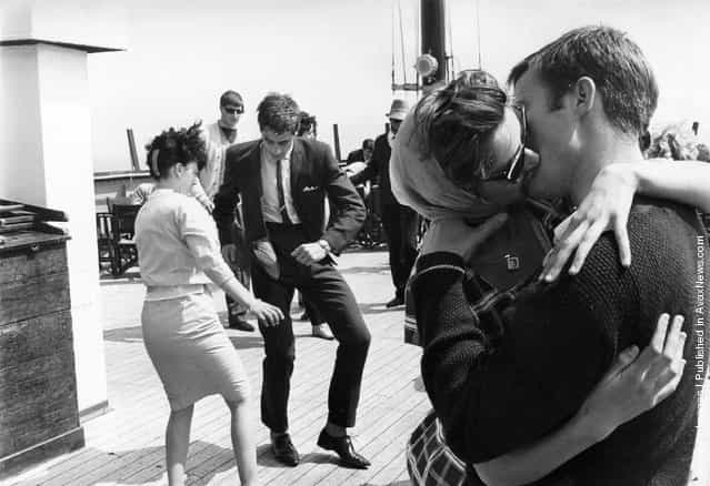 1962: One couple dance the Twist as another kiss on board the steamer the Royal Daffodil during a special cross-Channel trip, with ten bands on board providing music for twelve hours of constant twisting