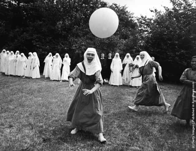 A group of nuns play basketball outdoors at the Ladywell Convent, Godalming, England, 1965