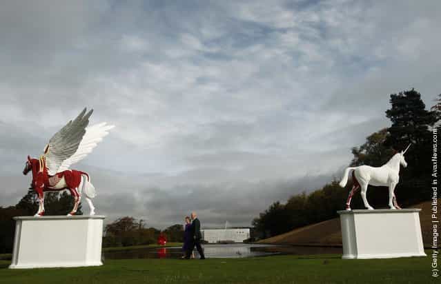 The Duke and Duchess of Devonshire view the sculptures Legend (L) and Myth by Damien Hirst in the gardens of their home Chatsworth House