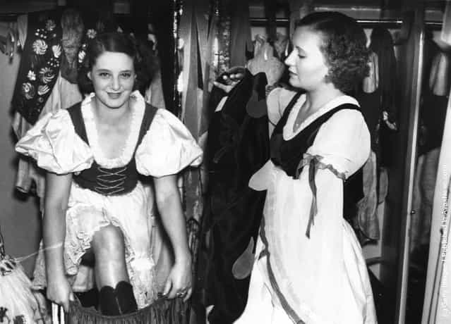 Dancers of the Blue Train cabaret troupe get into their costumes for a performance at the Prince of Wales Theatre in London