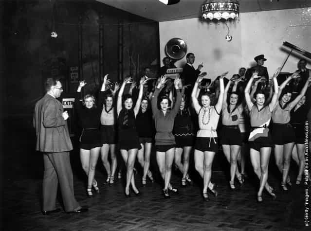 Mr. Andre Charlot rehearses his chorus for the cabaret section of the Grand Ball at the Royal Opera House