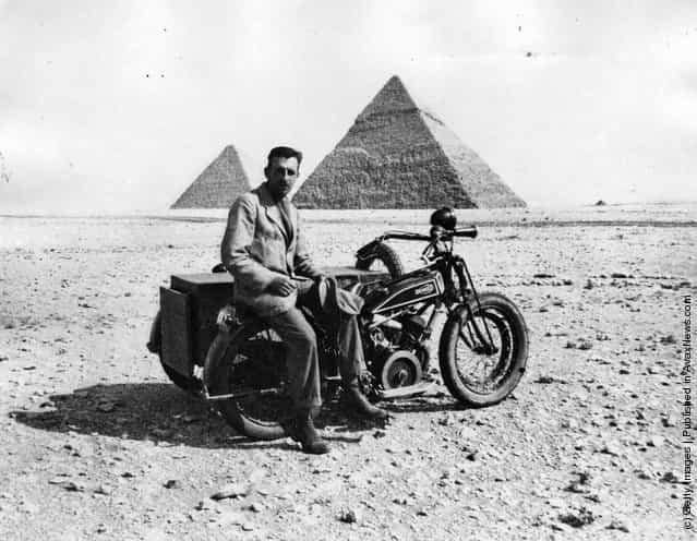 circa 1925: T. M. Moore, who crossed the Libyan desert on a motorbike, near the end of his journey, by the pyramids