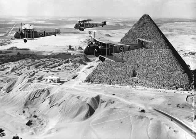 1936: Vickers Valentias bomber-transporters flying over the Pyramids in the Egyptian desert