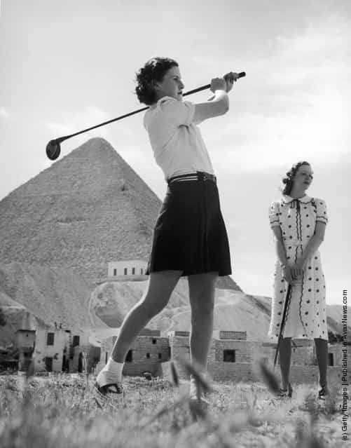 An English tourist drives off at the new Mena House Golf Course, situated almost at the foot of the Great Pyramid at Giza, near Cairo, Egypt, 1938