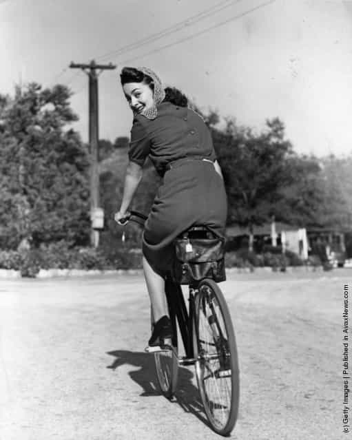 1938: Hollywood screen star Olivia De Havilland riding a bicycle