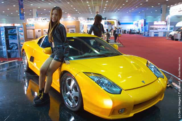 Models pose with the latest car SPARRA from Japanese car manufacturer Toyota at the Seoul Motor Show