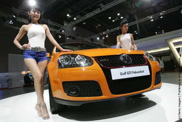 Models poses next to a Volkswagen Golf GTI Fahrenheit at the Seoul Motor Show