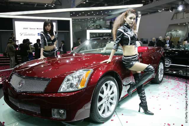 Models poses next to a Cadillac XLR at the Seoul Motor Show