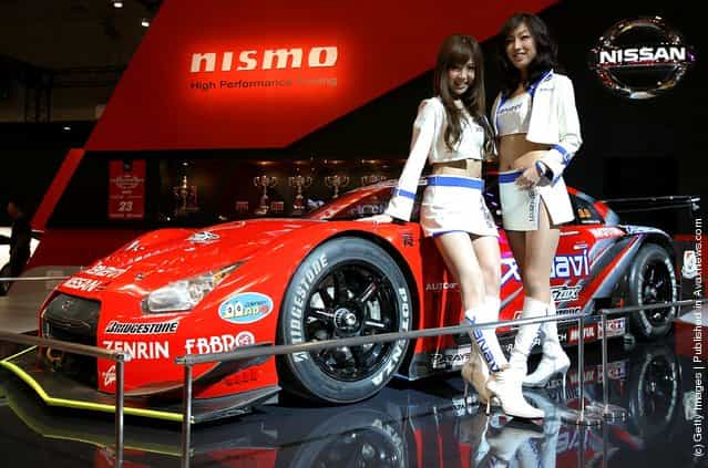 Model poses with Nissan Xanavi Nismo GT-R at a booth at Tokyo Auto Salon 2009