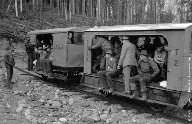 1940: Loggers employed at Messrs Bloedel, Stewart and Welch's logging operation in British Columbia travelling to work on the railway known as The Speeder