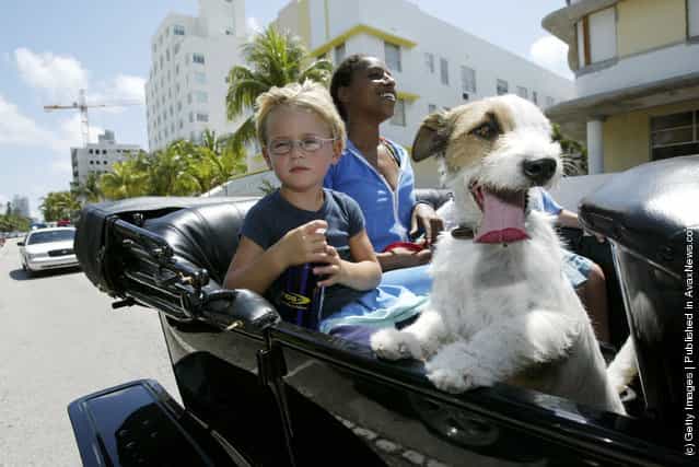 Leonardo Bode,4, from Miami, Florida and Naz Maizi from Miami, Florida take a spin in a Model T Ford