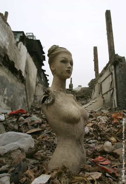 A sculpture is seen among the ruins of buildings