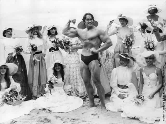 Arnold Schwarzenegger on Cannes beach during the Film Festival with the girls from the Folies Bergere, 1977