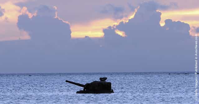 A tank remains in the sea close to a monument to the hundreds of Japanese civilians and soldiers who jumped off Banzai Cliff to their deaths to avoid capture by the invading American army at Banzai Cliff on June 26, 2005 in Saipan, Northern Mariana Islands