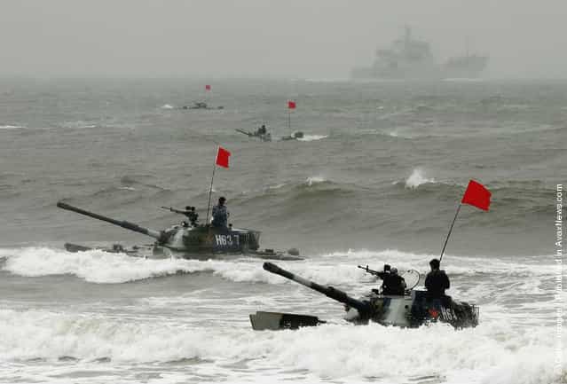 Amphibious tanks of the Chinese Peoples Liberation Army land on a beach